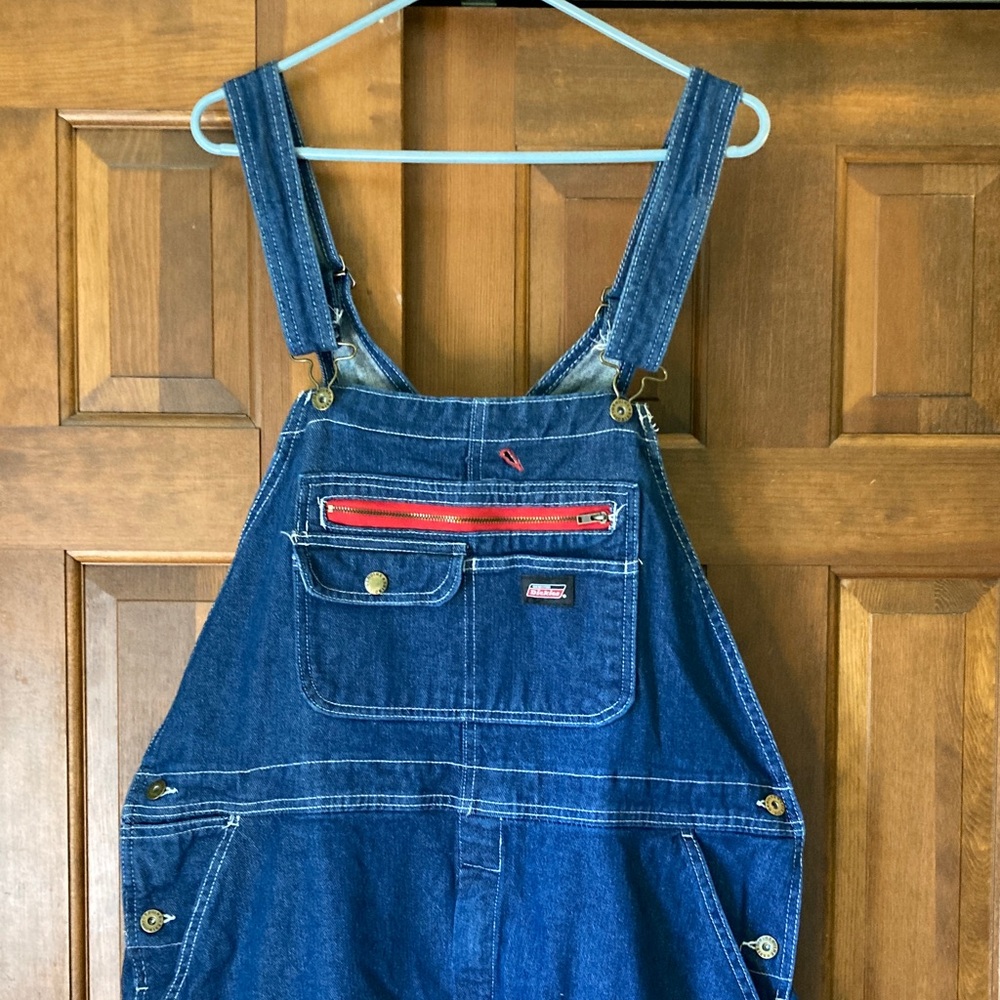Genuine Dickies Brand Overalls
Dark Denim blue /red trim
Size large 
Waist 21”
